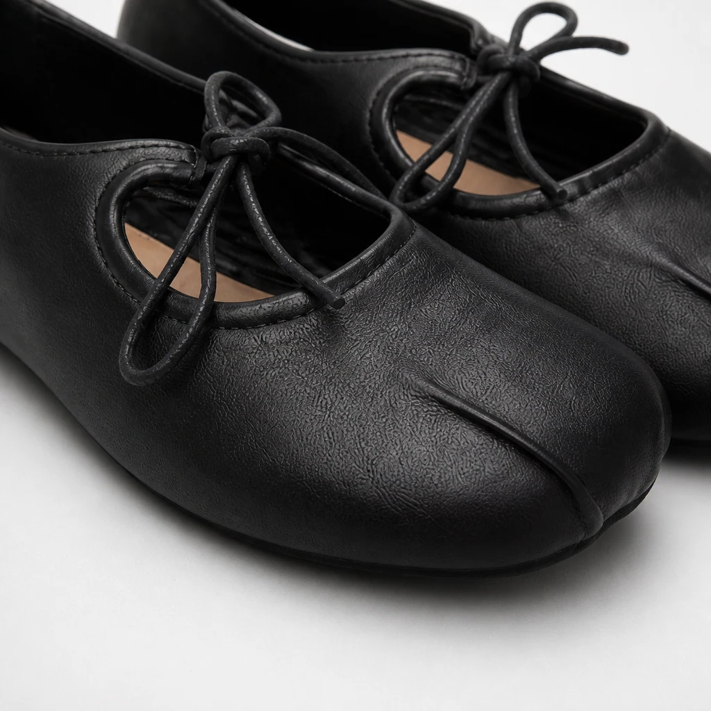 Close-up detail of the soft upper and tie construction on the walking flats